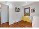 Bright bedroom featuring hardwood floors, natural light from the window, and closet storage space at 1568 S Osceola Way, Denver, CO 80219