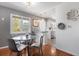 Bright dining area featuring hardwood floors, modern decor, and easy access to the kitchen at 1568 S Osceola Way, Denver, CO 80219
