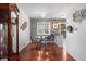 The dining area is well-lit, with hardwood floors and a modern table and chairs, open to the kitchen at 1568 S Osceola Way, Denver, CO 80219