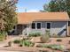 Charming single-story home featuring a well-kept landscaped yard with gravel, plants, and inviting curb appeal at 1568 S Osceola Way, Denver, CO 80219