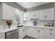 Bright kitchen featuring white cabinets, stainless steel appliances, and sleek countertops at 1568 S Osceola Way, Denver, CO 80219