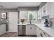 Bright kitchen featuring white cabinets, stainless steel appliances, and sleek countertops at 1568 S Osceola Way, Denver, CO 80219