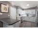 Bright kitchen featuring white cabinets, stainless steel appliances, and gray walls at 1568 S Osceola Way, Denver, CO 80219