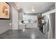 Bright kitchen featuring white cabinets, stainless steel appliances, and gray walls at 1568 S Osceola Way, Denver, CO 80219