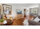 Inviting living room features hardwood floors, a mounted TV, and a comfortable seating arrangement at 1568 S Osceola Way, Denver, CO 80219