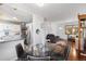 Open-concept living space with hardwood floors, modern decor, and stainless steel appliances at 1568 S Osceola Way, Denver, CO 80219