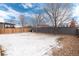 Spacious, level backyard with new fence, partial winter covering of snow at 12569 S Sopris Creek Dr, Parker, CO 80134
