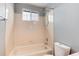 This bathroom features a tub/shower combo and neutral paint and tile at 12569 S Sopris Creek Dr, Parker, CO 80134