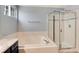 Relax in the garden tub or shower in this well-appointed bathroom with vanity and neutral tile at 12569 S Sopris Creek Dr, Parker, CO 80134