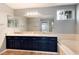 Elegant bathroom features granite countertops, dual sinks, and a large mirror with vanity lighting at 12569 S Sopris Creek Dr, Parker, CO 80134