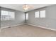 Spacious bedroom is complete with multiple windows, ceiling fan, and soft neutral carpeting at 12569 S Sopris Creek Dr, Parker, CO 80134