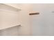 Clean and organized walk-in closet with white shelving and wooden coat rack at 12569 S Sopris Creek Dr, Parker, CO 80134
