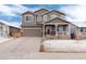 Inviting two-story home with a covered front porch, neutral paint, attached garage, and landscaped front yard at 12569 S Sopris Creek Dr, Parker, CO 80134