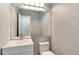 Clean half bathroom with modern fixtures, a large mirror, and neutral wall paint at 12569 S Sopris Creek Dr, Parker, CO 80134