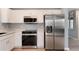 Bright kitchen featuring modern appliances, white cabinetry, and granite countertops at 12569 S Sopris Creek Dr, Parker, CO 80134
