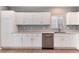 Bright kitchen features white cabinetry, stainless steel appliances, and granite countertops at 12569 S Sopris Creek Dr, Parker, CO 80134