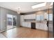 Modern kitchen with white cabinets, hardwood floors, stainless steel appliances, and sliding glass doors at 12569 S Sopris Creek Dr, Parker, CO 80134