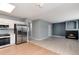 Open-concept living space with a fireplace and modern kitchen appliances nearby at 12569 S Sopris Creek Dr, Parker, CO 80134