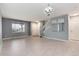 Bright and airy living room featuring a modern chandelier, hardwood floors, and large windows at 12569 S Sopris Creek Dr, Parker, CO 80134