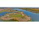 Scenic aerial view of a community park, pond and walking trails surrounded by natural beauty at 13802 Quartz St, Mead, CO 80504