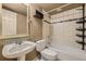 Cozy bathroom featuring tiled shower, sink, toilet and storage shelves at 22911 E Euclid Cir, Aurora, CO 80016