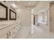 Luxurious primary bathroom features double vanity, marble floors, and a soaking tub with a glass-enclosed shower at 22911 E Euclid Cir, Aurora, CO 80016