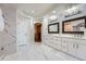 Elegant bathroom featuring marble flooring, double sinks, and a luxurious soaking tub at 22911 E Euclid Cir, Aurora, CO 80016