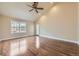 Spacious bedroom with vaulted ceilings, hardwood floors, a window, and a door to the backyard at 22911 E Euclid Cir, Aurora, CO 80016