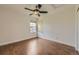 Cozy bedroom with hardwood floors, natural light from two windows, and a ceiling fan at 22911 E Euclid Cir, Aurora, CO 80016