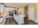 Well-appointed kitchen featuring a center island, stainless steel appliances, and white cabinets at 22911 E Euclid Cir, Aurora, CO 80016