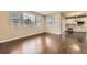 Bright and airy living room, showcasing hardwood floors and a view into the kitchen and dining area at 22911 E Euclid Cir, Aurora, CO 80016