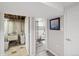 Basement bathroom featuring shower with a glass partition, updated fixtures, and decorative tile at 2792 S Stuart St, Denver, CO 80236