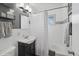 Modern bathroom featuring updated shower with a glass partition, updated fixtures, and decorative tile at 2792 S Stuart St, Denver, CO 80236