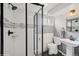 Modern bathroom featuring shower with a glass partition, updated fixtures, and decorative tile at 2792 S Stuart St, Denver, CO 80236