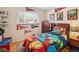 A colorful bedroom features posters, sports and Marvel-themed decor, and a large window with a view at 2792 S Stuart St, Denver, CO 80236