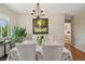 Bright dining room features a table with a patterned cloth, a chandelier, and a view into another room at 2792 S Stuart St, Denver, CO 80236
