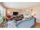 Comfortable living room with a plush blue sofa, stylish decor, and lots of natural light from the large window at 2792 S Stuart St, Denver, CO 80236