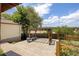 Backyard featuring a pergola with seating, a concrete patio, and mature trees at 4647 W Dakota Ave, Denver, CO 80219