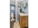 Well-lit bathroom with a modern vanity, updated fixtures, and stylish decor at 4647 W Dakota Ave, Denver, CO 80219