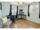 Bright bedroom with two windows, wood-look flooring, and workspace for home office at 4647 W Dakota Ave, Denver, CO 80219