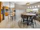 Open dining area flowing from the kitchen, featuring a round dining table and modern seating at 4647 W Dakota Ave, Denver, CO 80219