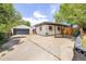 Charming single-story home features a detached garage, concrete driveway, and a covered patio, perfect for outdoor relaxation at 4647 W Dakota Ave, Denver, CO 80219