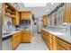 Well-lit kitchen with wood cabinets, modern appliances, and ample counter space at 4647 W Dakota Ave, Denver, CO 80219