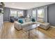 Bright living room featuring modern furnishings, hardwood floors, and scenic views from the windows at 4647 W Dakota Ave, Denver, CO 80219