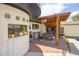 Outdoor kitchen and dining area with covered pergola and built in grill at 4647 W Dakota Ave, Denver, CO 80219