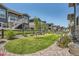 Landscaped backyard with green lawn, mature trees, and a stylish fence, offering a serene outdoor space at 21985 E Bailey Pl, Aurora, CO 80016
