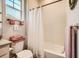 Well-lit bathroom features a shower-tub combo, toilet, and soft, decorative towels at 21985 E Bailey Pl, Aurora, CO 80016