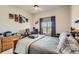 Bedroom features a cozy bed, a window with curtains, a desk, and unique decor at 21985 E Bailey Pl, Aurora, CO 80016
