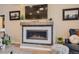 Cozy living room features a modern fireplace, complementing decor, and a mounted television for entertainment at 21985 E Bailey Pl, Aurora, CO 80016
