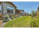 Beautiful front yard with lush green lawn, mature landscaping, and attractive stone accents at 21985 E Bailey Pl, Aurora, CO 80016